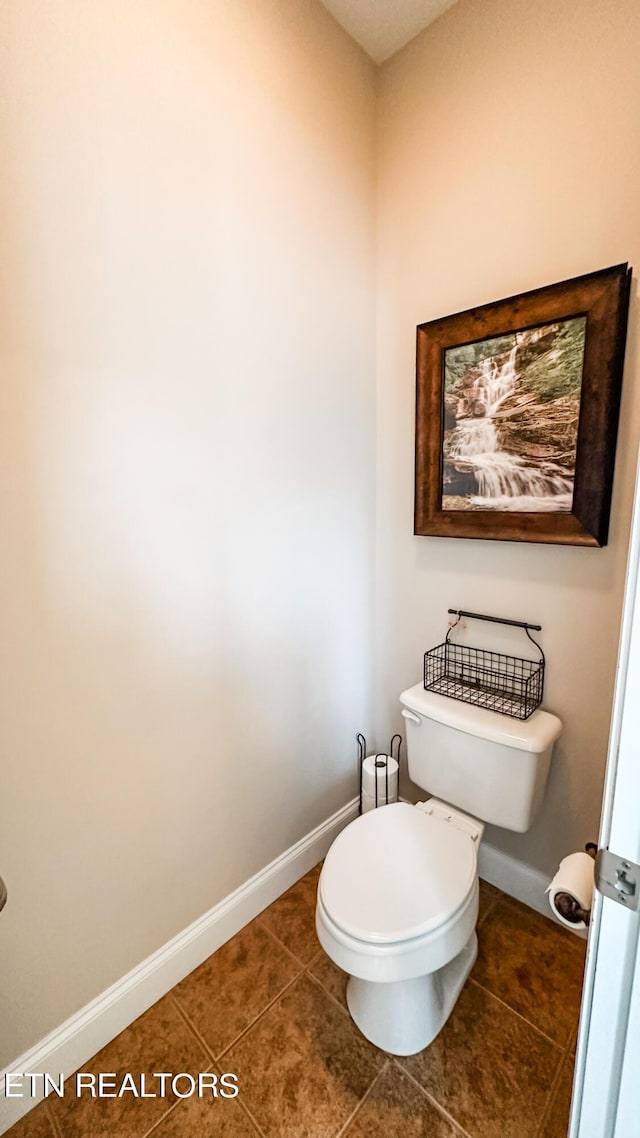 bathroom featuring toilet and tile patterned flooring