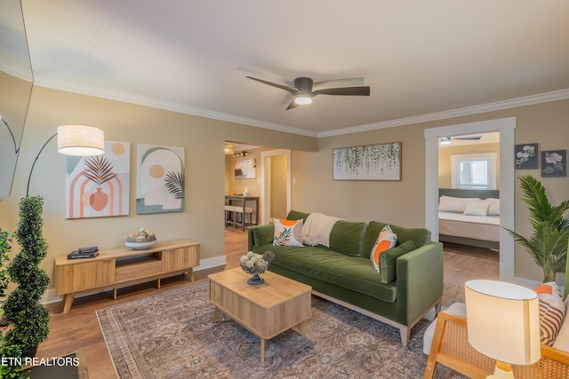 living room featuring crown molding, ceiling fan, and hardwood / wood-style flooring