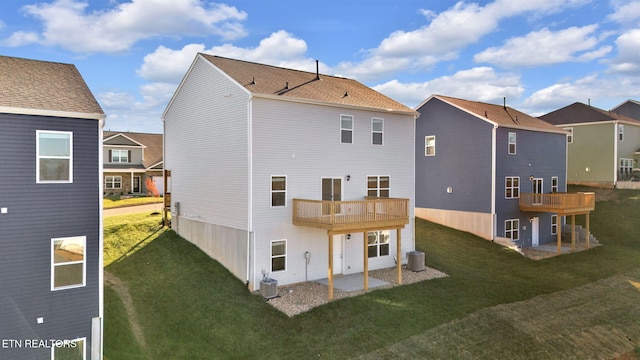 rear view of house featuring central AC, a yard, a balcony, and a patio