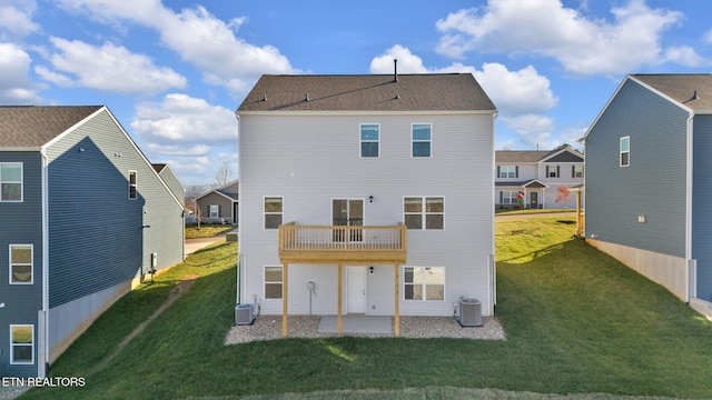 rear view of house featuring a patio area, cooling unit, a lawn, and a balcony