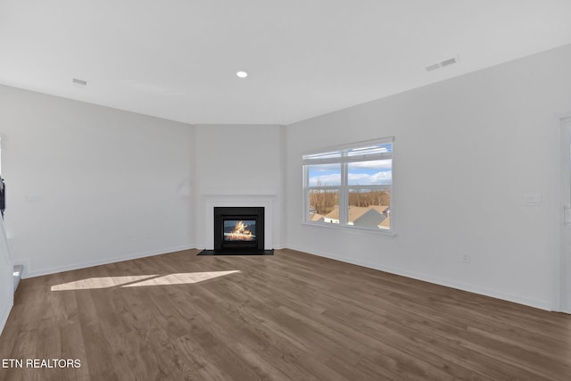 unfurnished living room with dark wood-type flooring