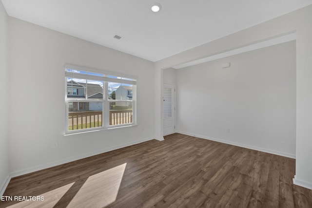 unfurnished room featuring dark hardwood / wood-style flooring