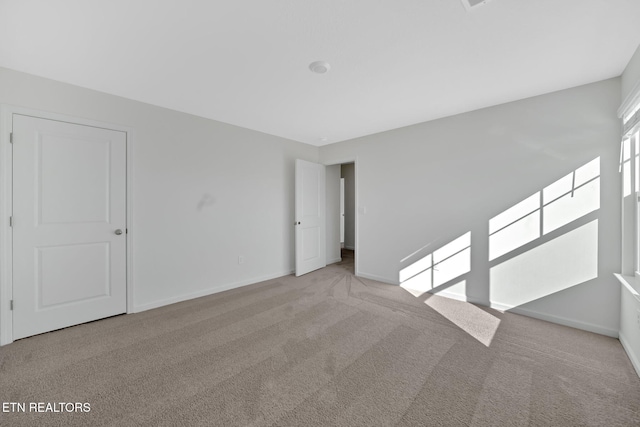 unfurnished room with light carpet