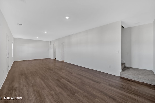 unfurnished room with dark hardwood / wood-style flooring