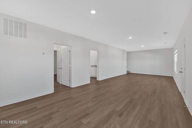 spare room with dark hardwood / wood-style floors