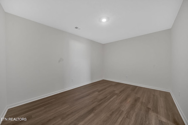 unfurnished room featuring dark hardwood / wood-style flooring