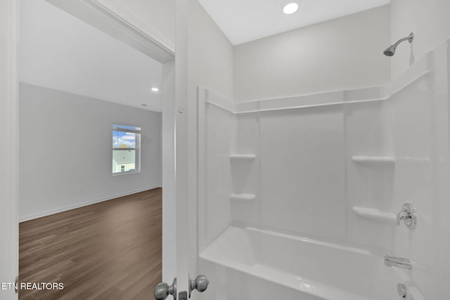 bathroom with hardwood / wood-style floors and shower / bathing tub combination