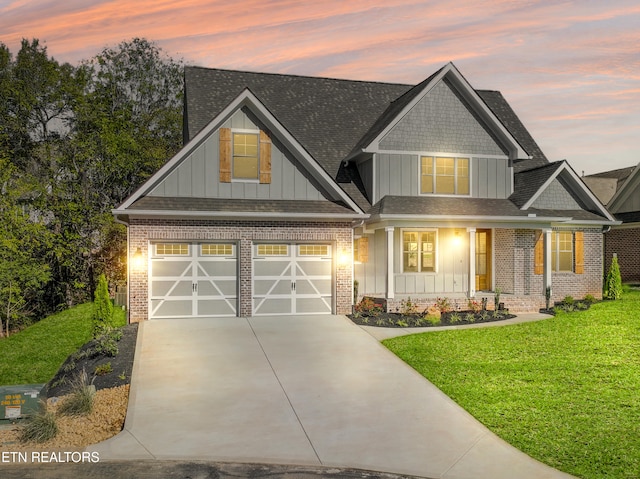 craftsman house with a garage and a lawn