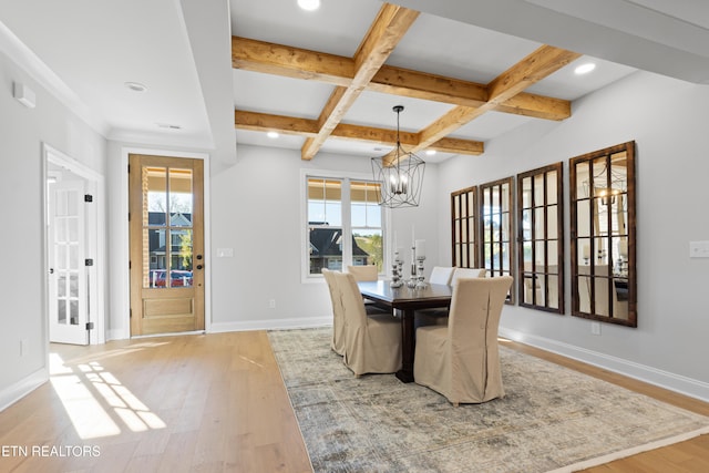 dining room featuring coffered ceiling, a notable chandelier, beam ceiling, and light wood-type flooring