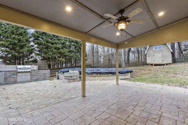 view of patio featuring area for grilling, ceiling fan, and an outdoor kitchen