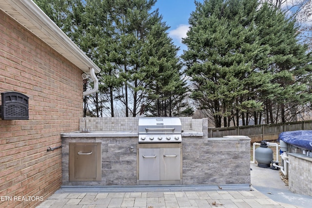 view of patio / terrace featuring a grill and exterior kitchen