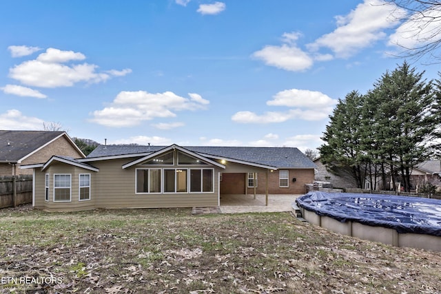 back of house with a patio and a covered pool