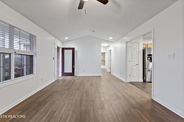 empty room featuring wood-type flooring, ceiling fan, and lofted ceiling