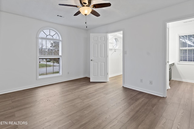 spare room with ceiling fan and light wood-type flooring