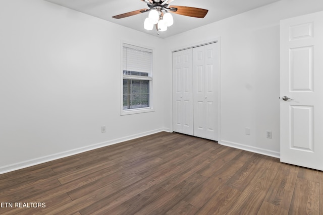 unfurnished bedroom with a closet, dark hardwood / wood-style floors, and ceiling fan