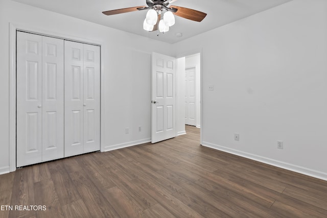 unfurnished bedroom featuring ceiling fan, dark hardwood / wood-style flooring, and a closet