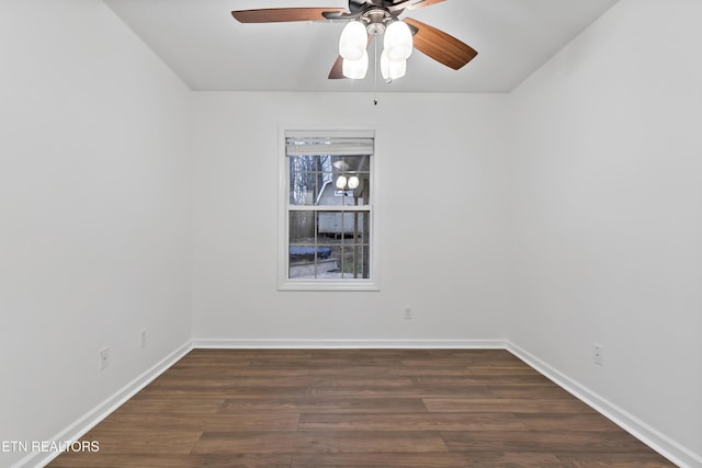 spare room featuring ceiling fan and dark wood-type flooring