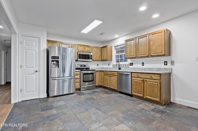 kitchen featuring light stone countertops and stainless steel appliances