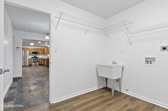 washroom featuring electric dryer hookup, washer hookup, and dark hardwood / wood-style floors