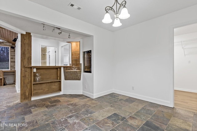 unfurnished dining area with a chandelier