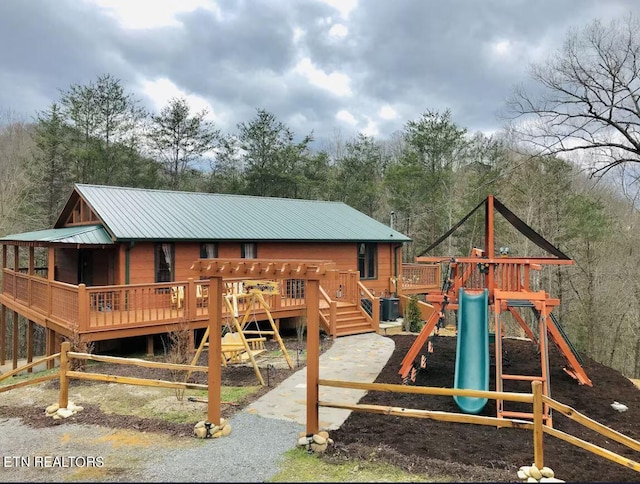 view of playground featuring a wooden deck