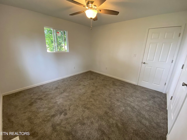 carpeted spare room featuring ceiling fan