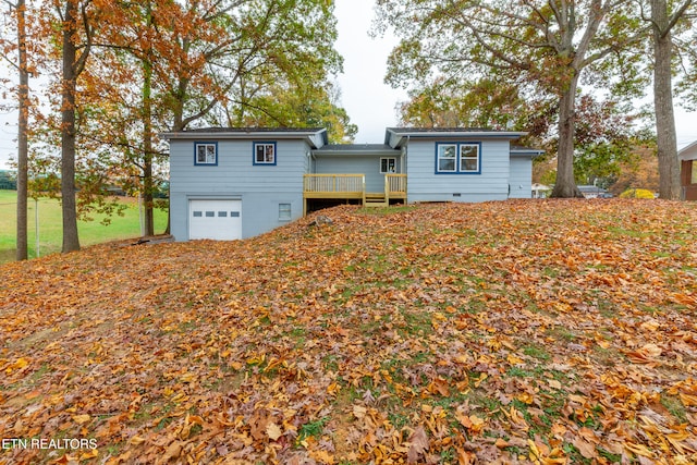 single story home with a garage and a deck