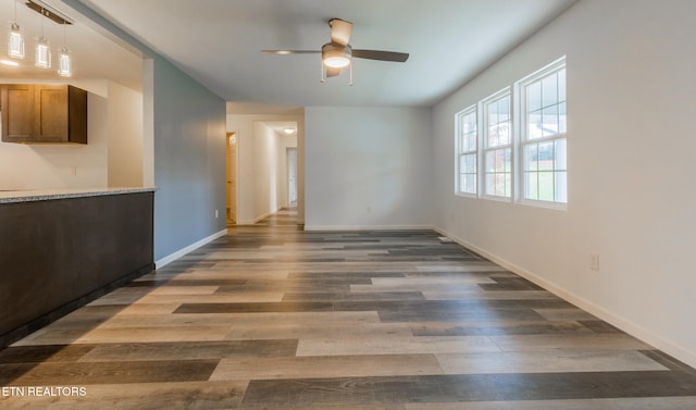 interior space with dark hardwood / wood-style flooring and ceiling fan