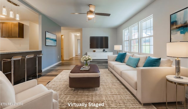 living room featuring ceiling fan and light hardwood / wood-style flooring