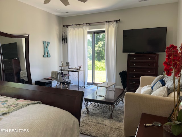 bedroom with access to outside, hardwood / wood-style floors, and ceiling fan