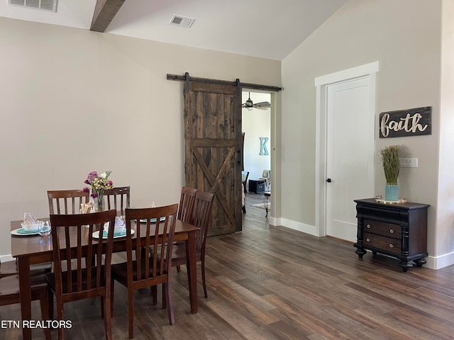 dining room featuring dark hardwood / wood-style flooring, a barn door, and vaulted ceiling with beams