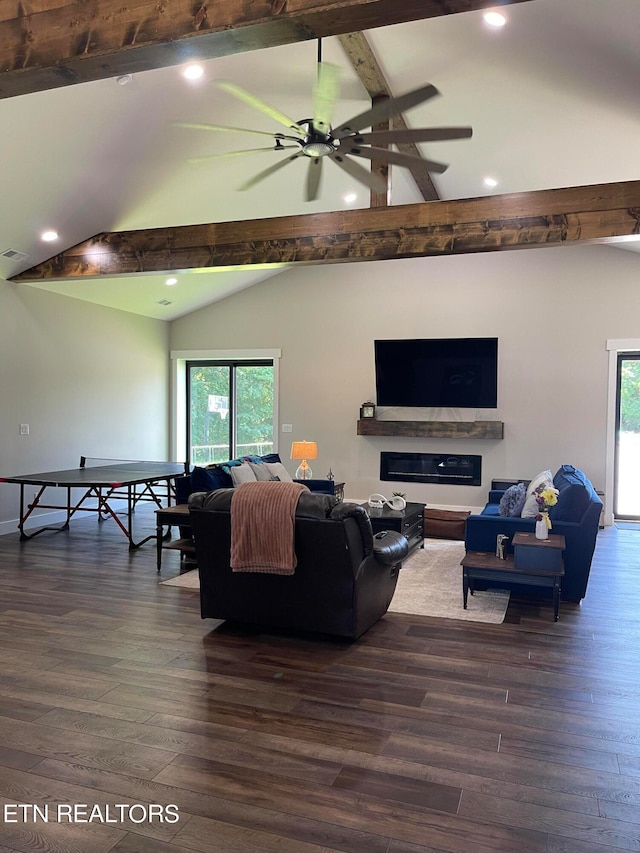 living room featuring hardwood / wood-style flooring, vaulted ceiling with beams, and ceiling fan