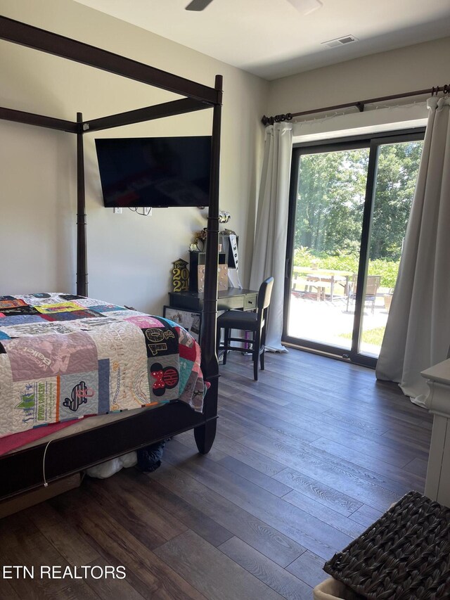 bedroom featuring hardwood / wood-style flooring, multiple windows, and access to exterior