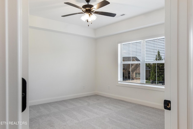 carpeted empty room featuring plenty of natural light and ceiling fan