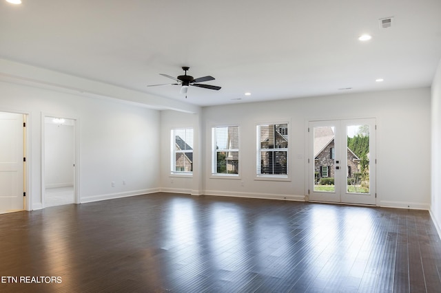 unfurnished living room featuring plenty of natural light, dark wood-type flooring, ceiling fan, and french doors