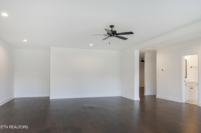 empty room featuring dark hardwood / wood-style flooring and ceiling fan