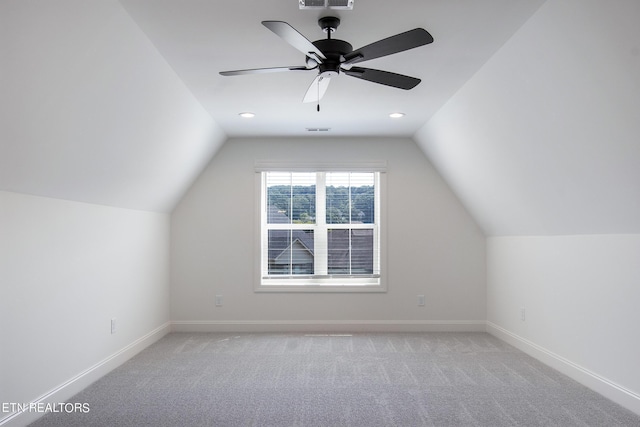 additional living space featuring ceiling fan, vaulted ceiling, and light carpet