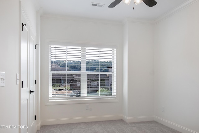 carpeted spare room with ornamental molding and ceiling fan