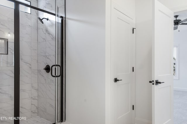 bathroom with ceiling fan and a shower with shower door