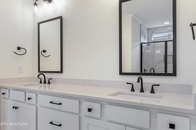 bathroom featuring vanity and an enclosed shower