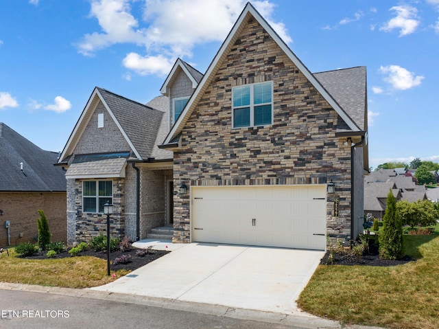 view of front of home featuring a garage and a front lawn