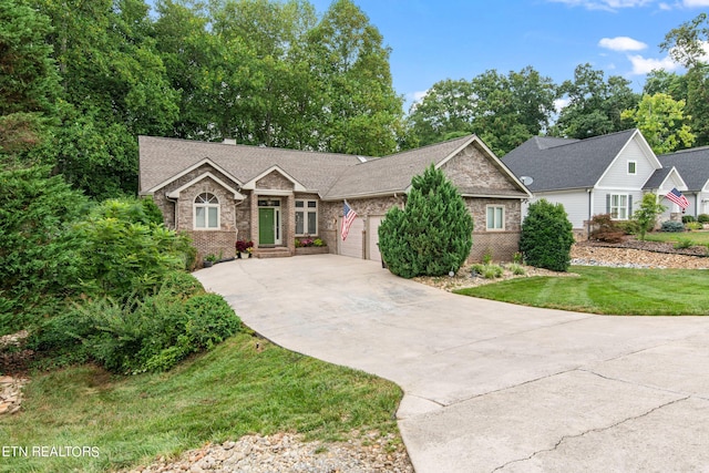 ranch-style house featuring a garage and a front lawn