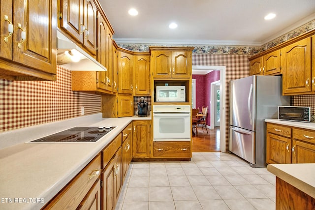 kitchen featuring light tile patterned floors, ornamental molding, decorative backsplash, and white appliances