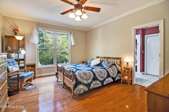 bedroom with ceiling fan, light hardwood / wood-style flooring, and crown molding