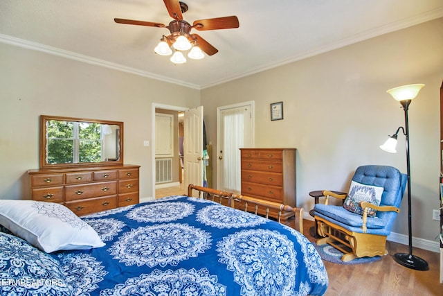 bedroom featuring ceiling fan, crown molding, and hardwood / wood-style floors