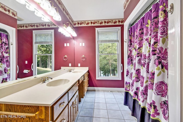 bathroom with tile patterned flooring, plenty of natural light, and vanity