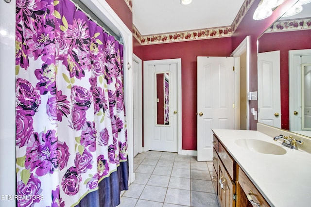 bathroom featuring vanity, tile patterned flooring, and curtained shower