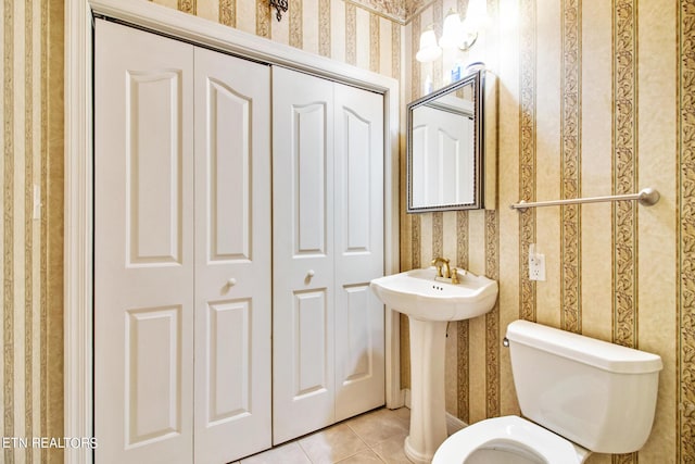 bathroom featuring sink, tile patterned floors, and toilet