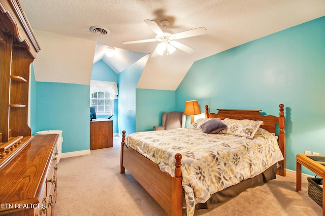 carpeted bedroom with ceiling fan, a textured ceiling, and vaulted ceiling