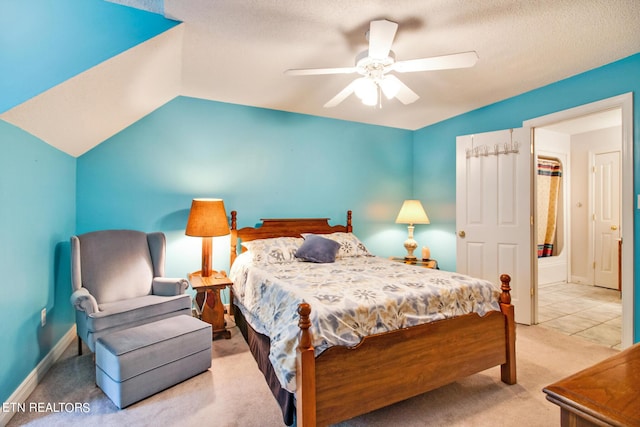 bedroom with vaulted ceiling, ceiling fan, a textured ceiling, and light carpet